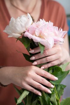 girl's hands with a beautiful pink manicure design, pastel color, gently, flowers in spring. High quality photo