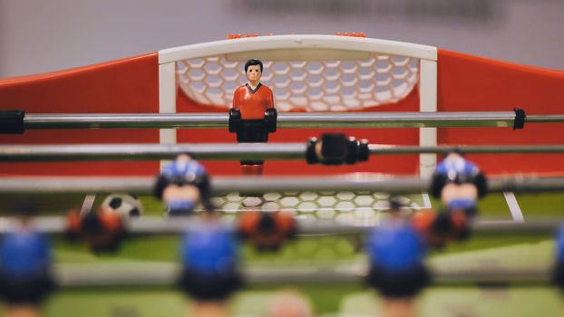 Players play table football in the clubhouse
