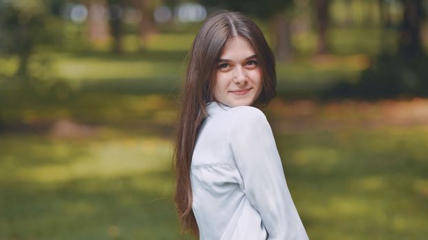 Portrait of a smiling young Georgian girl in a park