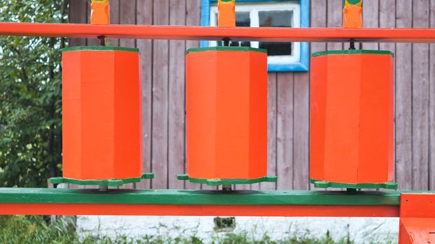 Rotation of the red prayer drums outside the Buddhist temple