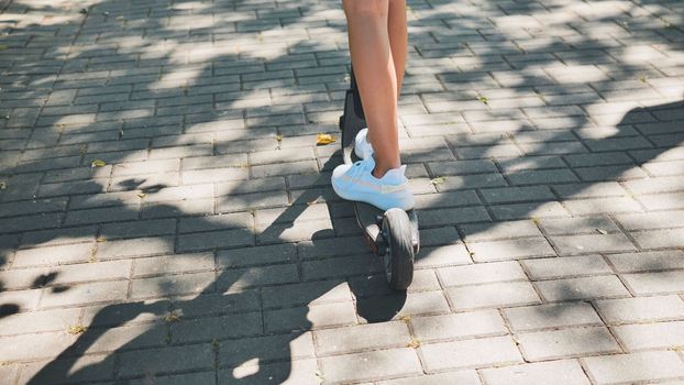 A girl rolls around on city tiles in the park