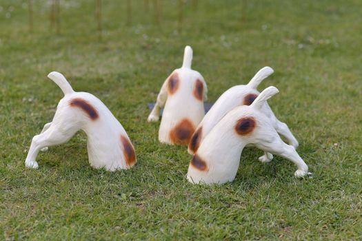 Ceramic dogs hid their heads in the ground