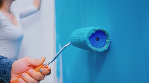 Roller brush on wall during home decoration. Apartment makeover. Home decoration and renovation in cozy apartment flat, repair and makeover