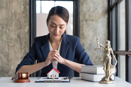 Real estate concept, businesswoman holding a house icon. House on Hand.Property insurance and security concept. Protecting gesture of female and symbol of house