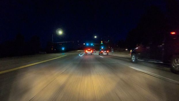 Denver, Colorado, USA-January 17, 2020 - Driving on typical paved roads at night in suburban America.