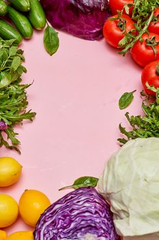 fresh vegetables on a pink background with copyspaced in the top right corner, and an image of red cabbage next to it