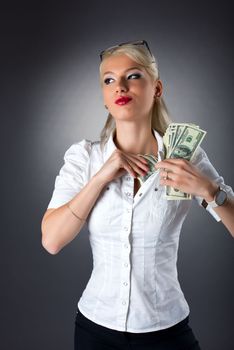 Beauty blond woman hide dollars under shirt