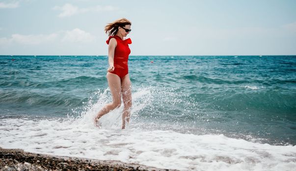 Young happy woman walks carefree on the seaside . Portrait beautiful young woman relax smile around beach sea ocean in holiday vacation travel trip