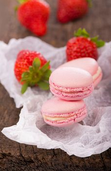 Macaroon with raspberries cookies on a wooden table
