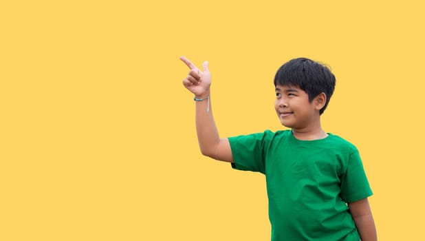 The boy smiled and pointed his hand to his side. on a yellow background