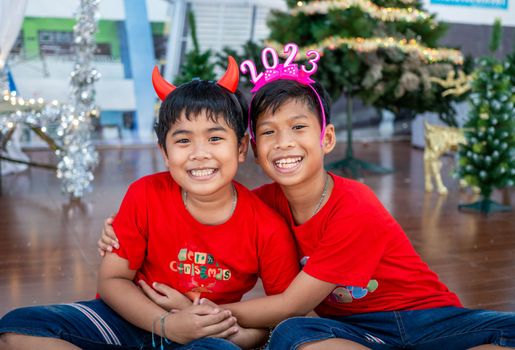 Brothers hugging each other at Christmas To show love within the family. Christmas Festival.