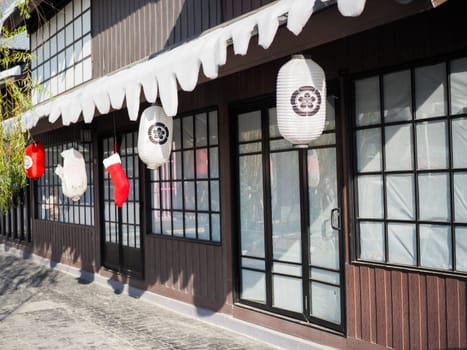 Japanese lantern hung in front of Japanese Restaurant, Japanese text on lantern is "Sushi" Japanese food.