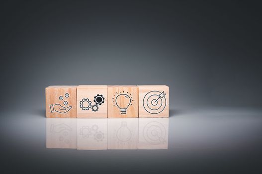 Wood cube block stacking with icon.Concept of business strategy and goal action plan. 