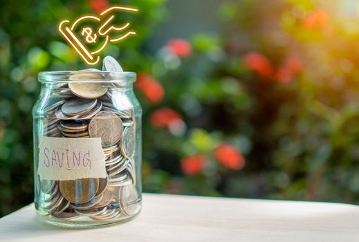 Coins in glass bottles on nature background. The concept of savings and investment.