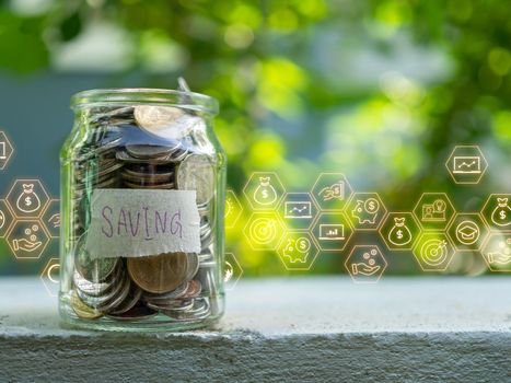 Coins in glass bottles on nature background. The concept of savings and investment.