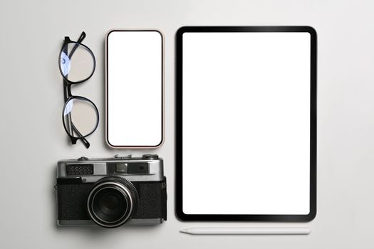 Mock up digital tablet, smart phone, camera and glasses on white background.