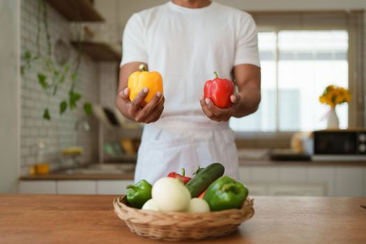 Portrait of beautiful young asian woman making salad at home. cooking food and Lifestyle moment.