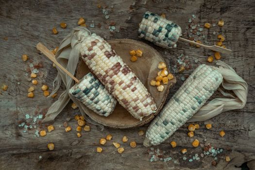 Fresh waxy corn or Sweet glutinous corn and Corn kernelson Rustic old wooden background. Tropical whole grain food, Top view, Selective focus.