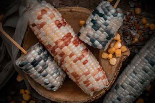 Close-up of Fresh waxy corn or Sweet glutinous corn and Corn kernelson Rustic old wooden background. Tropical whole grain food, Top view, Selective focus.