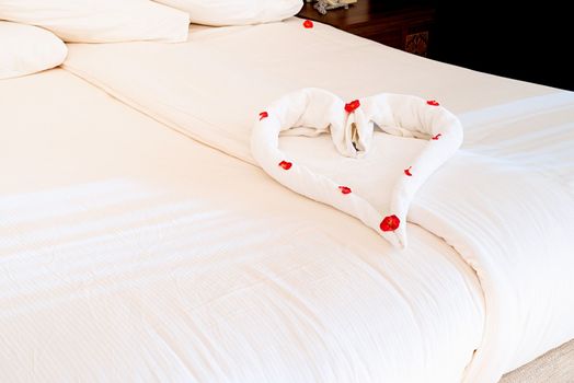 towel heart shape on the bed