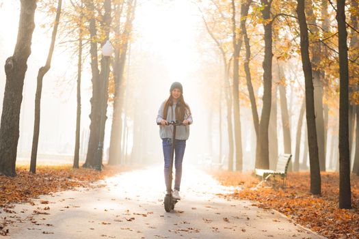 girl on scooter in autumn park