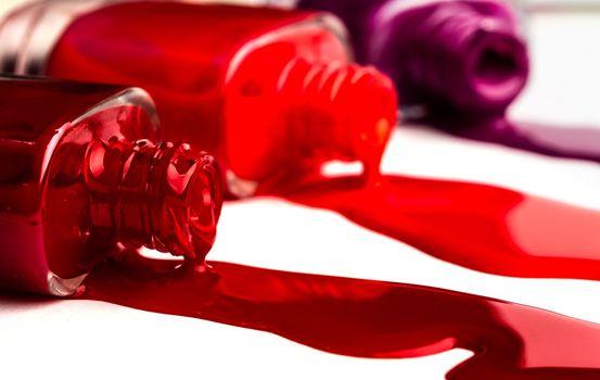 Bright colours of nail polish leaking from bottles
