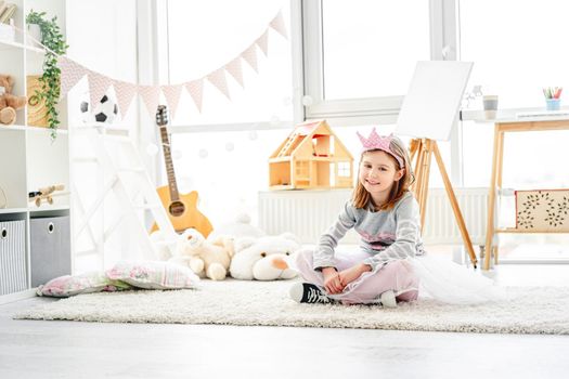 Cute little princess sitting in children's room