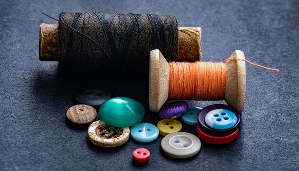 Colorful sewing buttons and thread spools macro