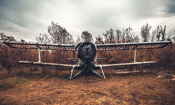 Abandoned old USSR airplane at the airfield at autumn. Broken military aviation technique