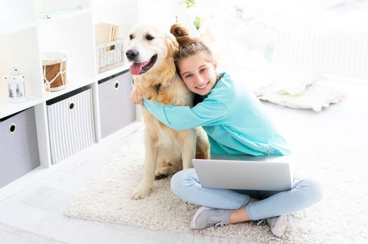 girl with pretty dog with laptop in bright room