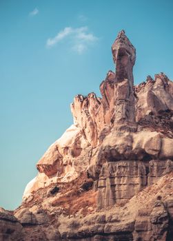 Unusual rocky mountains on blue sky background in Cappadocia, Turkey