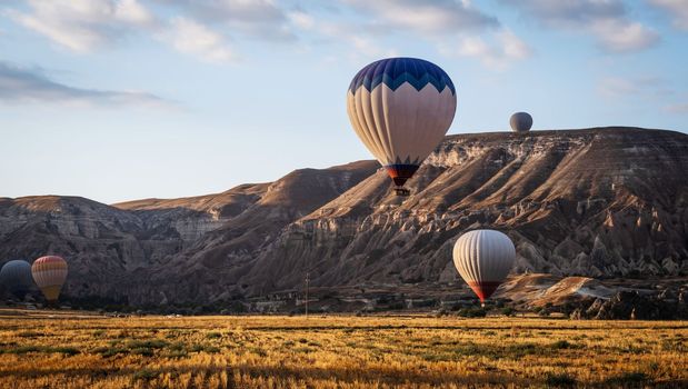 Flying hot air balloon during romantic festival in Cappadocia, Turkey