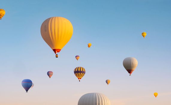 Colorful hot air balloons flying in clear blue sky