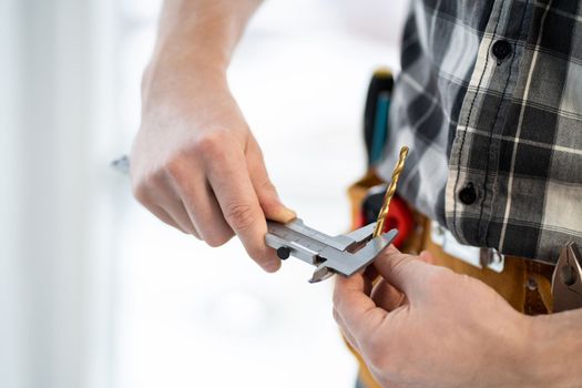 Master measuring drill diameter using calipers in light workshop