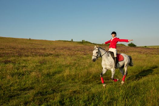 The sportswoman on a horse. The horsewoman on a red horse. Equestrianism. Horse riding racing. Rider on a horse.