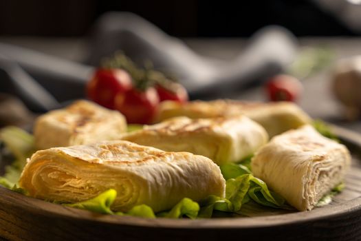 Delicious fried pita bread roll with cottage cheese and herbs. Fried puff rolls of thin Armenian lavash stuffed with cottage cheese. Wrapped tortillas. Traditional cuisine. Delicious and healthy food.
