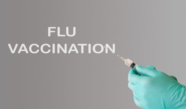 flu vaccination text on gray background. Flu protection concept