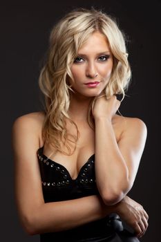 Studio portrait of pretty blonde woman in leather corset