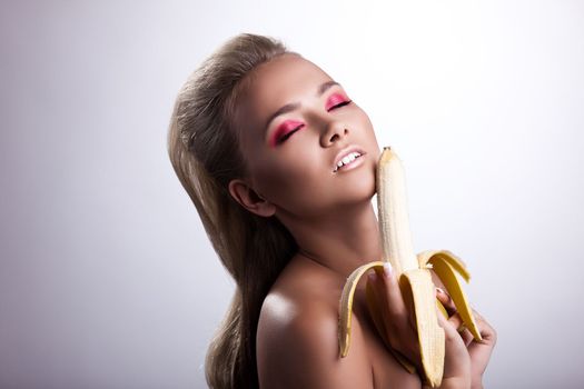sexy desired young woman posing with long banana