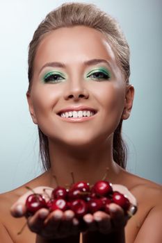 Smile young woman sexy offer your taste of cherry