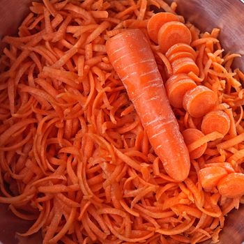 Carrots, grated, sliced ​​and whole in a metal dish