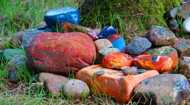 Colorful stones at the foot of a tree. Seen in a wood in Itterbeck, Germany