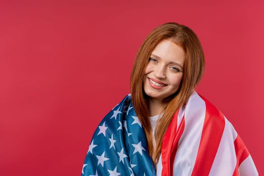 Smiling woman with national USA flag on viva magenta background. American patriot, 4th of July - Independence day celebration, election, America, labor. US banner. High quality photo