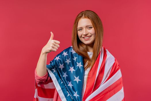 Woman showing like thumb up sign gesture. She with national USA flag on pink background. American patriot, 4th of July - Independence day celebration, election, America, labor. US banner. High quality