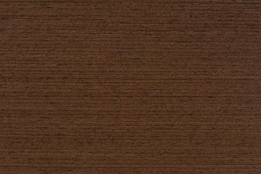 Texture of wenge wood. Dark brown wood for furniture or flooring. Close-up of a Wenge wooden plank, top view