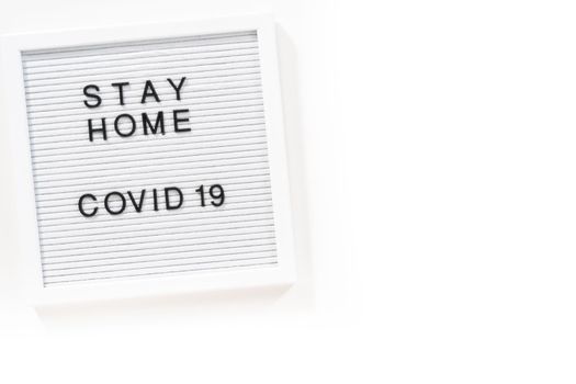 STAY HOME and COVID-19 sign on message board.