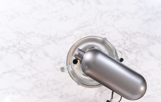Flat lay. Kneading bread dough in a kitchen mixer with a dough hook to prepare dinner rolls.