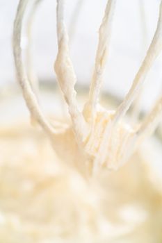 Whipping white ganache in kitchen mixer to make the white chocolate ganache frosting.