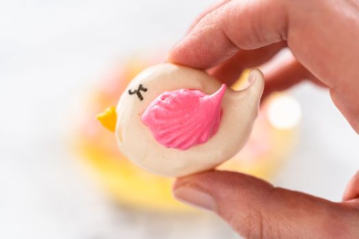 Freshly baked Easter meringue cookies in the shape of birds.