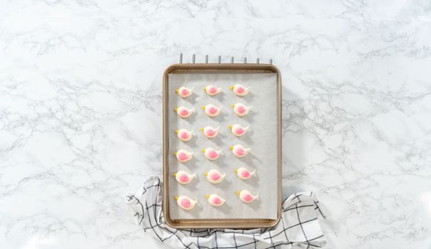 Freshly baked Easter meringue cookies in the shape of birds.